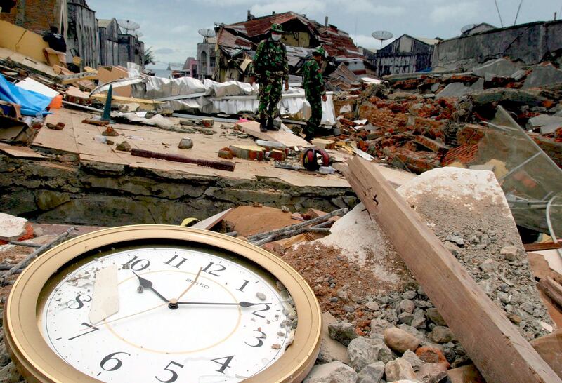 Rescue workers survey the destruction caused by an 8.7 magnitude earthquake that shook Indonesia's Sumatra island in March 2005, killing 915 people