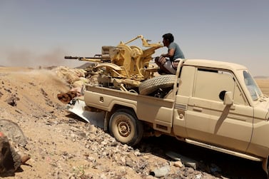  A Yemeni government fighter fires at a frontline position during battle with Houthi militants in Marib, Yemen. Reuters 