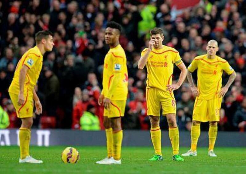 Liverpool's Philippe Coutinho, left, Raheem Sterling, Steven Gerrard and Martin Skrtel prepare to kick off after cenceding their second goal during their English Premier League football match against Manchester United on December 14, 2014. AFP PHOTO / OLI SCARFF