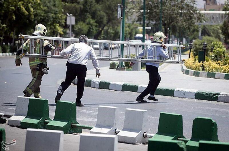 Members of Iranian civil defence run during an attack on the Iranian parliament in central Tehran, Iran. Tasnim News Agency / Handout via Reuters