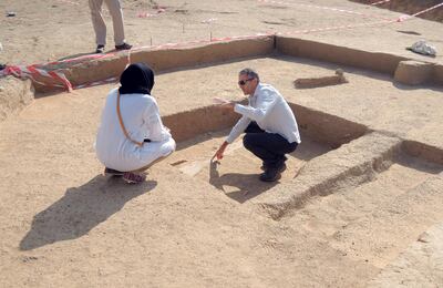 DCT archaeologist Peter Sheehan showing an Early Islamic irrigation channel in al-Ain to a student from Zayed University         