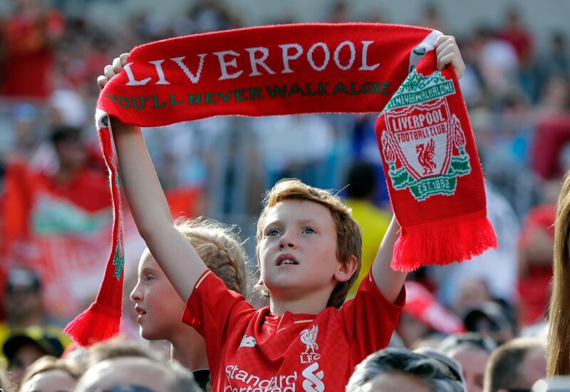 A Liverpool fan cheers during the match. AP Photo