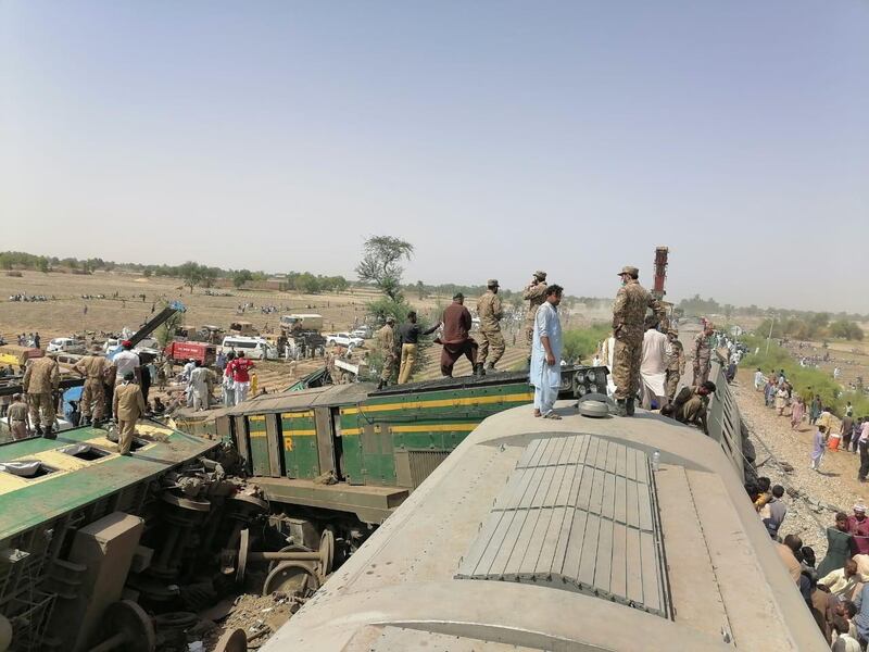 Paramilitaries and rescue workers gather at the site of a train crash in Ghotki, southern Pakistan. Reuters