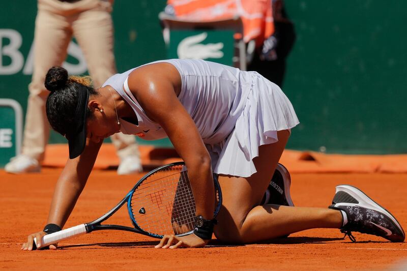 Japan's Naomi Osaka gets up after slipping during her third round match of the French Open tennis tournament against Katerina Siniakova of the Czech Republic at the Roland Garros stadium in Paris, Saturday, June 1, 2019. Osaka lost her match in two sets, 4-6, 2-6. (AP Photo/Michel Euler)