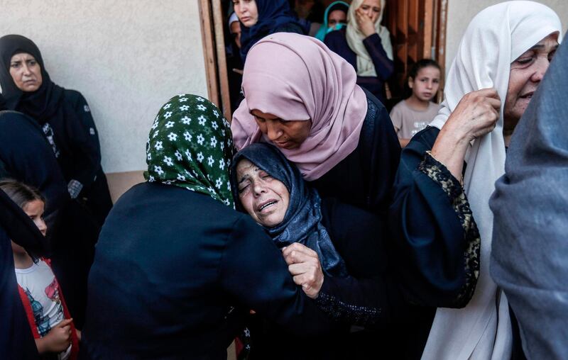 Relatives of Karim Abu Fatayer, a 30-year-old member of the Islamist movement Hamas' military wing Al-Qassam Brigades who was shot the day before while demonstrating near the border with Israel, mourn during his funeral. AFP