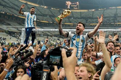 FILE - Argentina's Lionel Messi celebrates with the World Cup trophy in Lusail, Qatar, in December. AP Photo