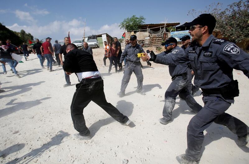 Israeli policemen disperse activists in the Palestinian Bedouin village of Khan al-Ahmar that Israel plans to demolish, in the occupied West Bank. Reuters