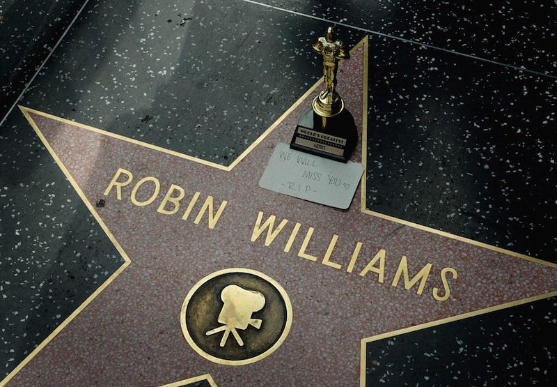 A minature Oscars statue and an "We will miss you" note is seen at Robin Williams' star on the Hollywood Walk of Fame is seen, August 11, 2014. AFP
