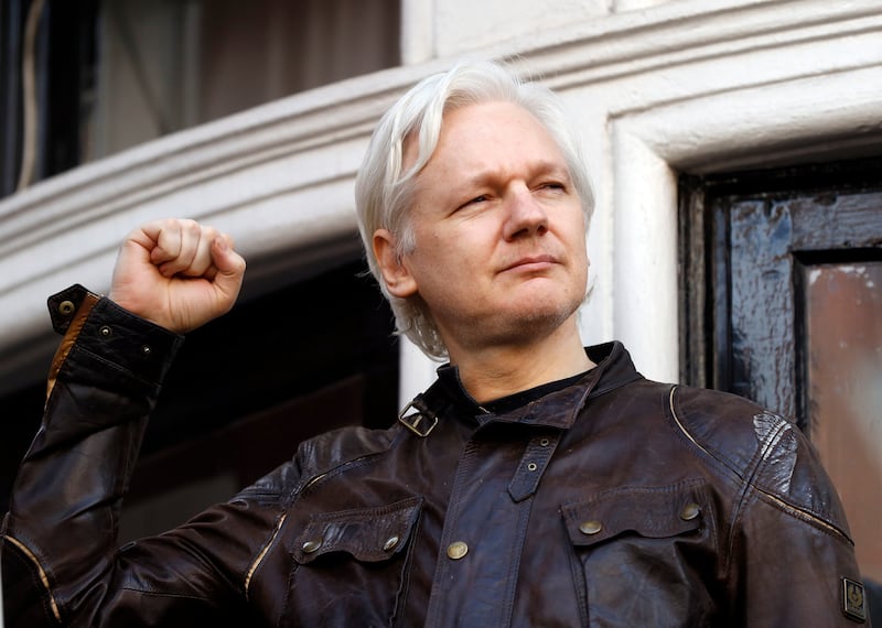 Julian Assange greets supporters outside the Ecuadorian embassy in London, in May 2017. AP