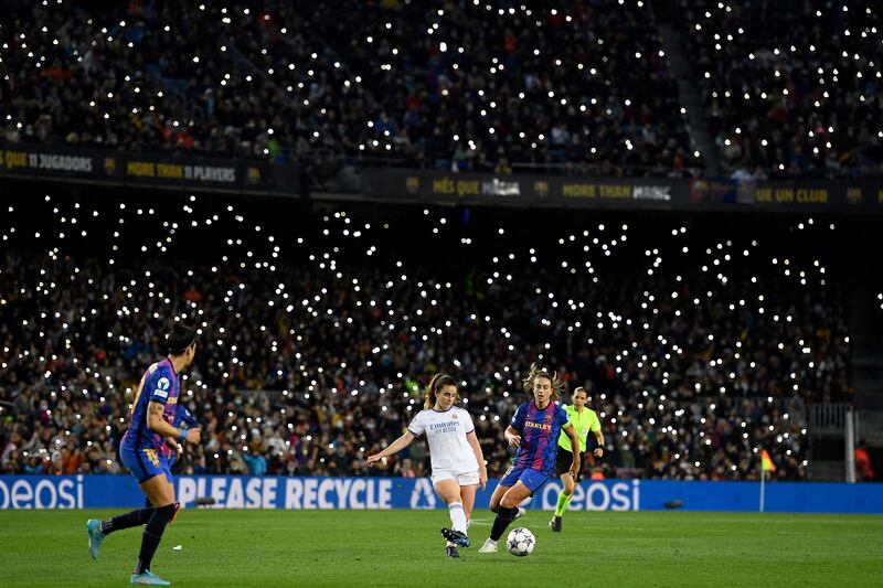 Fans light up the ground with their smartphone flashes. AFP