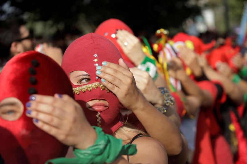 Women wearing masks take part in a protest against gender violence and the Chile's government in Santiago, Chile. Reuters