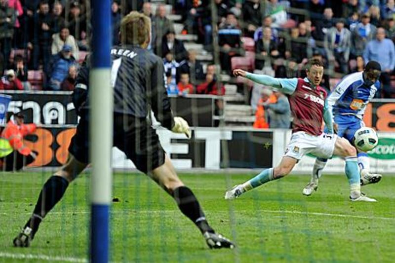 Wigan's Charles N'Zogbia, far right, scores the goal that relegated West Ham United from the Premier League yesterday.