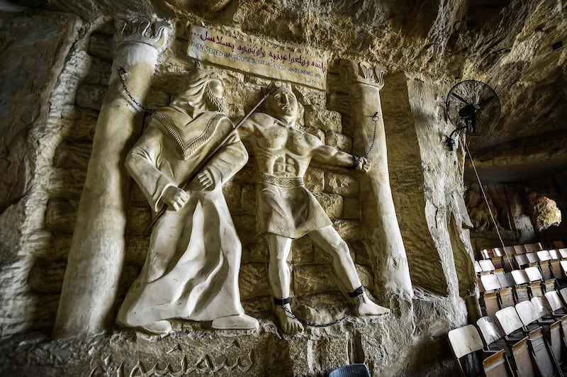 This picture taken shows a view of a relief sculpture made by Polish artist Mario at the St. Simon the Tanner Monastery complex in the Egyptian capital Cairo's eastern hillside Mokattam district, depicting the torture of the Old Testament Biblical figure Samson at the hands of the Philistines according to the Book of Judges. Mario spent more than two decades carving the rugged insides of the seven cave churches and chapels of the rock-hewn St. Simon Monastery and church complex atop Cairo's Mokattam hills, with designs inspired by biblical stories. It was all done to fulfil the wishes of the church's parish priest who met Mario in the early 1990s in Cairo. The Polish artist, who had arrived in Egypt earlier on an educational mission, was then looking for an opportunity to serve God at the monastery. AFP