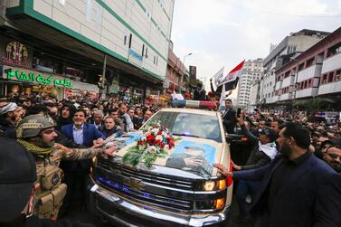 Mourners surround a car carrying the coffins of Iranian military commander Qassem Suleimani and Iraqi paramilitary chief Abu Mahdi Al Muhandis, killed in a US air strike, during their funeral procession in Kadhimiya, a Shiite pilgrimage district of Baghdad. AFP / SABAH ARAR