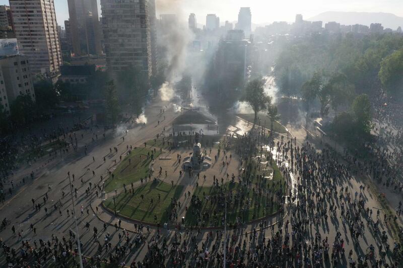 In this aerial view demonstrators clash with riot police at Plaza Baquedano, Santiago. Chile. AFP