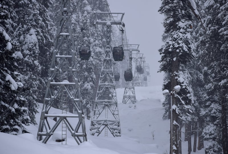 Cable car cabins pictured in January 2022 at Gulmarg, a scene that contrasts with this season's lack of snow. Reuters