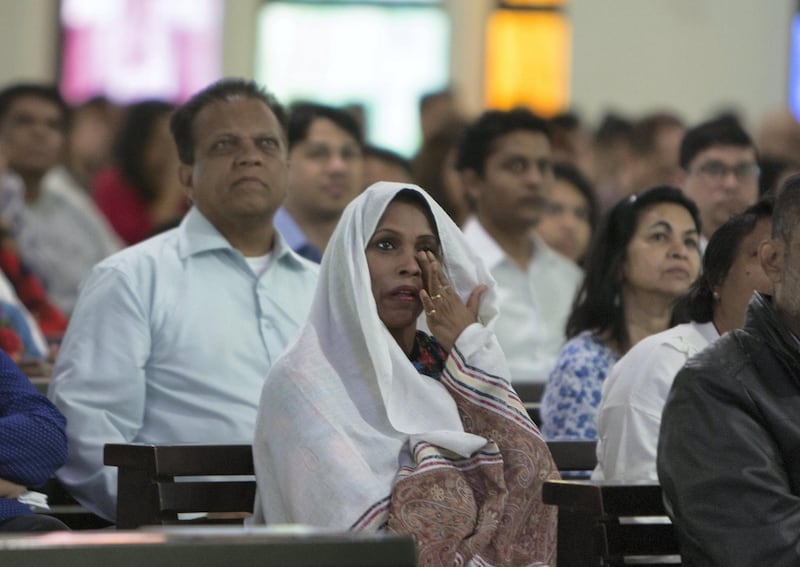 DUBAI, UNITED ARAB EMIRATES - Worshippers are emotional upon seeing the Pope on the screen at St. Mary's Church, Oud Mehta.  Leslie Pableo for The National for Nick Webster's story