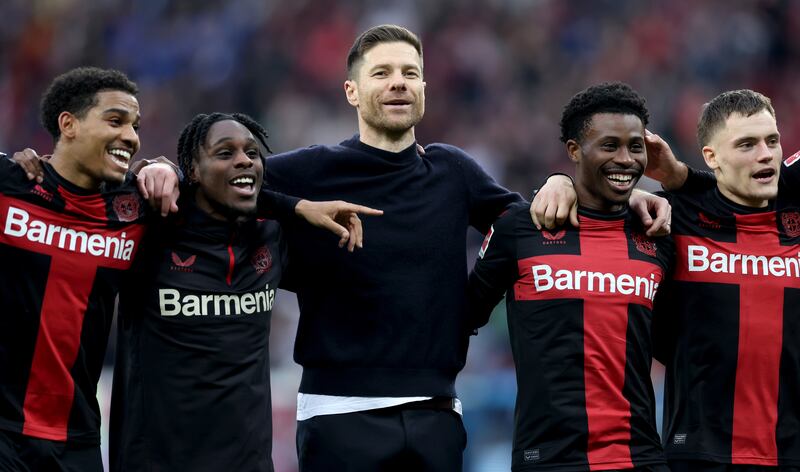Xabi Alonso, centre, head coach of Bayer Leverkusen, has his unbeaten team on course for a historic treble. Getty Images
