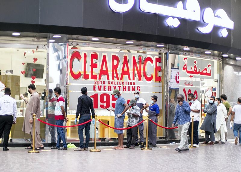DUBAI, UNITED ARAB EMIRATES. 4 JUNE 2020. 
People line outside a shop with a clearance sale in Al Sabkha. (Photo: Reem Mohammed/The National)

Reporter:
Section: