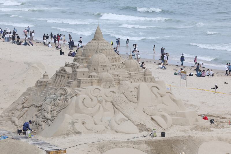 A huge sandcastle is built at Haeundae Beach in Busan, South Korea, on the last day of a long weekend to mark the Children's Day holiday. EPA