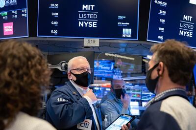 In this photo provided by the New York Stock Exchange, trader Thomas Ferrigno. left, works on the floor, Friday, Jan. 29, 2021. GameStop's stock is back to the races Friday, and the overall U.S. market is down again, as the saga that's captivated and confused Wall Street ramps up the drama. (Nicole Pereira/New York Stock Exchange via AP)