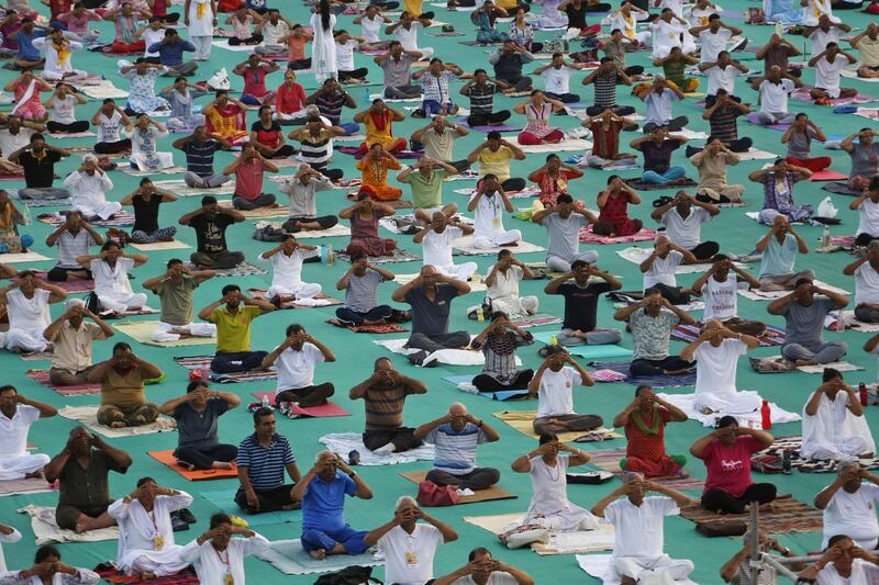 Indians participate in a yoga camp at Sardar Patel stadium ahead of International Day of Yoga in Ahmadabad. Ajit Solanki / AP Photo