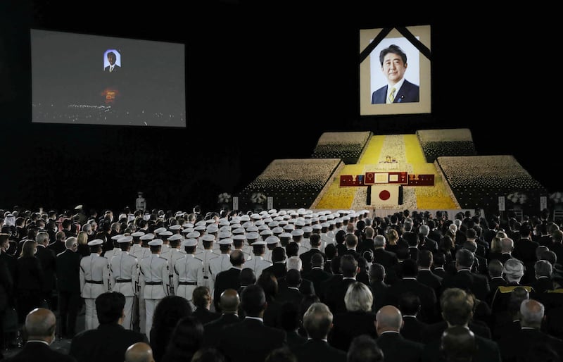 Guests stand at the start of the state funeral of former Japanese prime minister Shinzo Abe at the Nippon Budokan in Tokyo. Abe died at the age of 67 after being shot while campaigning in July. AFP