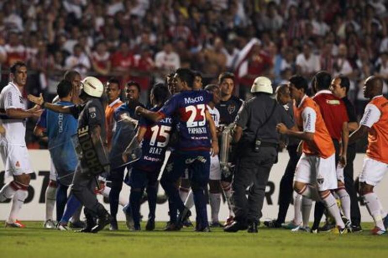 Security officials step in after Sao Paulo and Tigre players are involved in a fight at half time in the Copa Sudamericana final.