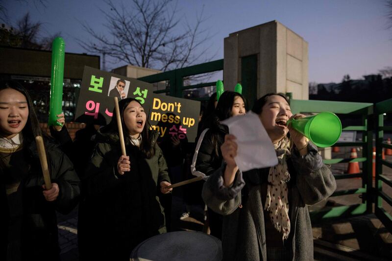 Students gather to cheer on others outside the Ehwa Girls Foreign Language High School in Seoul, South Korea. AFP