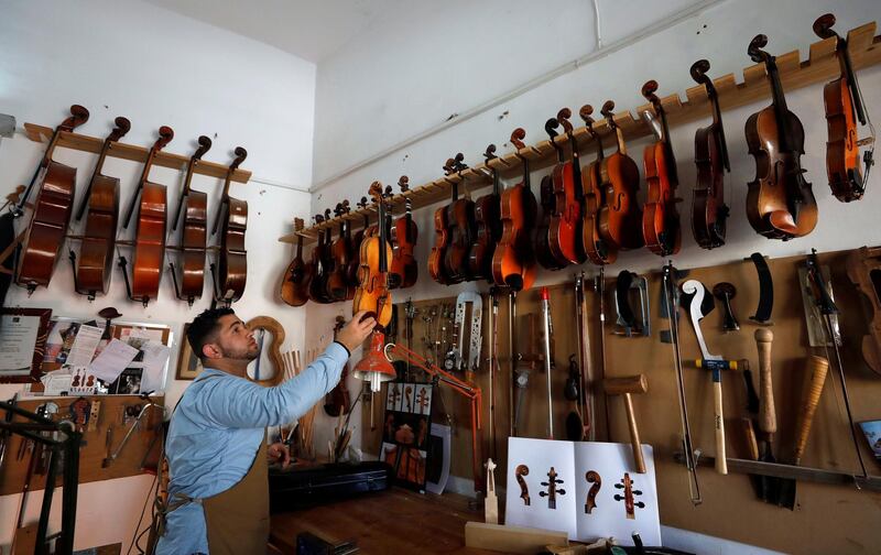 Palestinian violin-maker Shehada Shalalda, 28, arranges instruments at his workshop in Ramallah, in the Israeli-occupied West Bank. Reuters