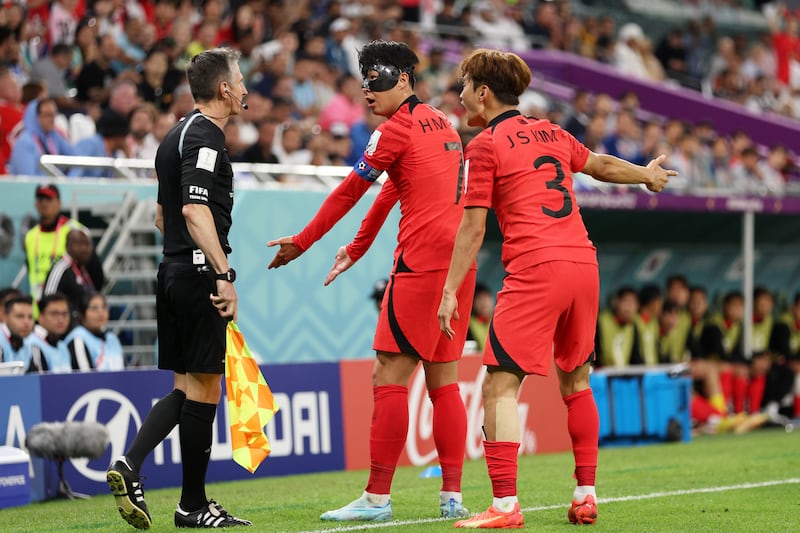 Son Heung-min and Kim Jin-su of South Korea argue with match official. Getty