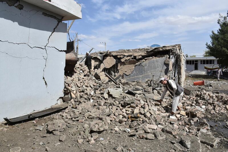 An Afghan man inspects the site of a bomb blast on an intelligence compound in Aybak, the capital of the Samangan province in northern Afghanistan. AP