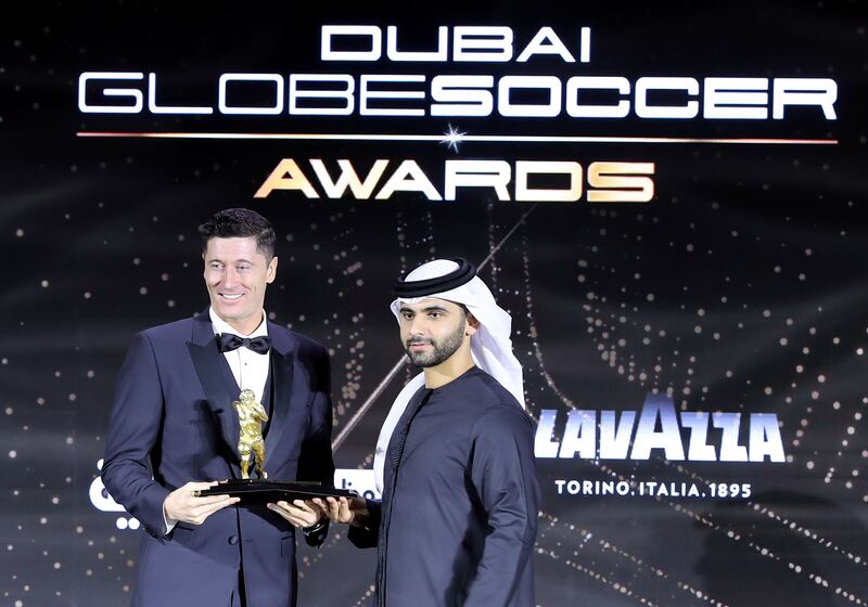 Poland and Bayern Munich star Robert Lewandowski receives the Maradona Award for best goalscorer of the year from Sheikh Mansoor bin Mohammed.