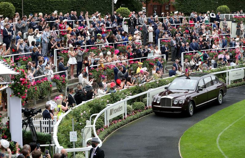 Crowds cheer and clap as Queen Elizabeth II arrives by car on day five of Royal Ascot at Ascot Racecourse. PA Images