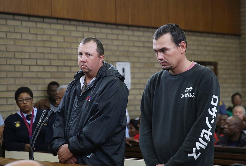 FILE -- In this Wednesday, Nov. 16, 2016 file photo Theo Jackson, left, and Willem Oosthuizen, right, appear in the Magistrates Court in Middelburg, South Africa, accused of forcing a black man into a coffin and threatening to set him on fire.  The two men have been convicted Friday Aug. 25, 2017, of attempted murder, kidnapping and other charges. (AP Photo, File)