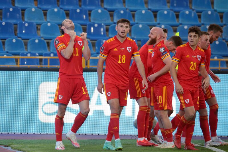 Wales forward Gareth Bale, left, celebrates with teammates after scoring the winner. AFP