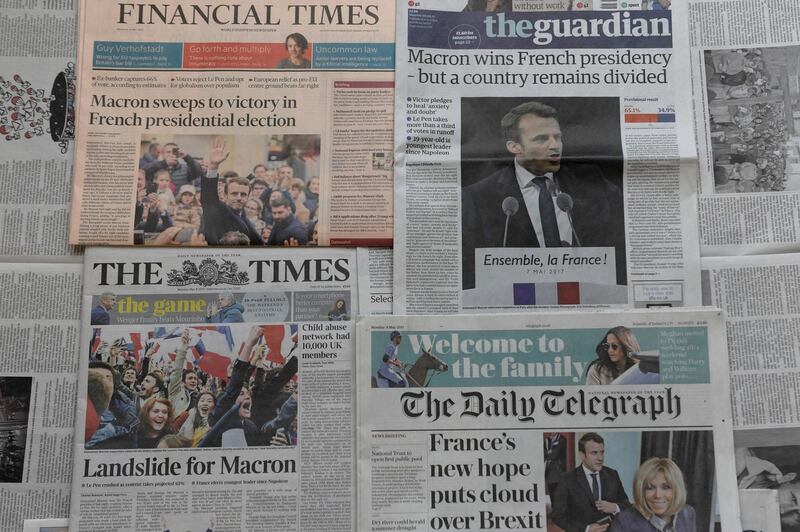 An arrangement of newspapers pictured in London on May 8, 2017, as an illustration, shows the front pages of the UK daily newspapers reporting on Emmanuel Macron's victory in the French presidential elections. - Macron won a resounding victory in the French presidential election but the focus shifted immediately to whether he can govern the country without the support of a traditional party. (Photo by Anna ZIEMINSKI / AFP)