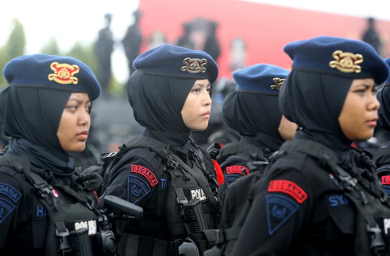 Female police officers stand to attention during a security parade. AP Photo