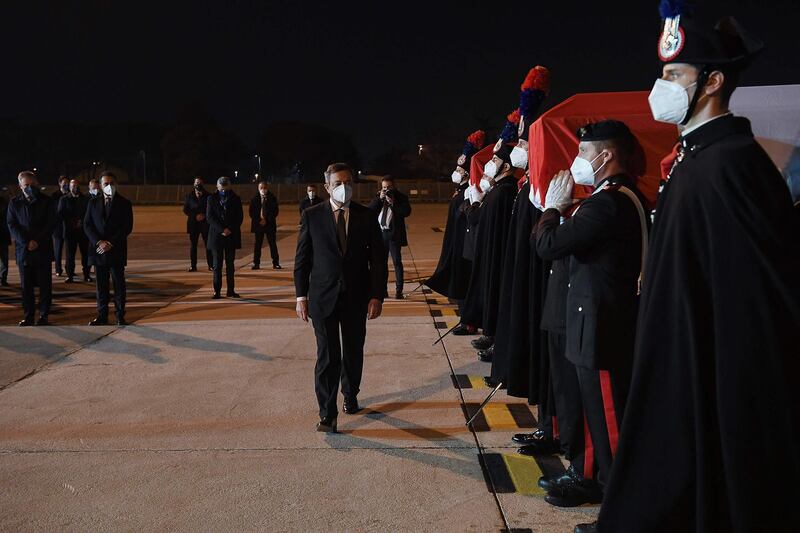 Prime Minister Draghi, Defence Minister Lorenzo Guerini, rear left, and Foreign Affairs Minister Luigi Di Maio, rear second left, attend a ceremony for the arrival of the coffins of the ambassador and police officer. AFP