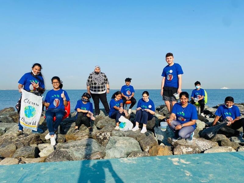 Pupils from Gems Legacy School collecting plastic waste during a beach clean-up.