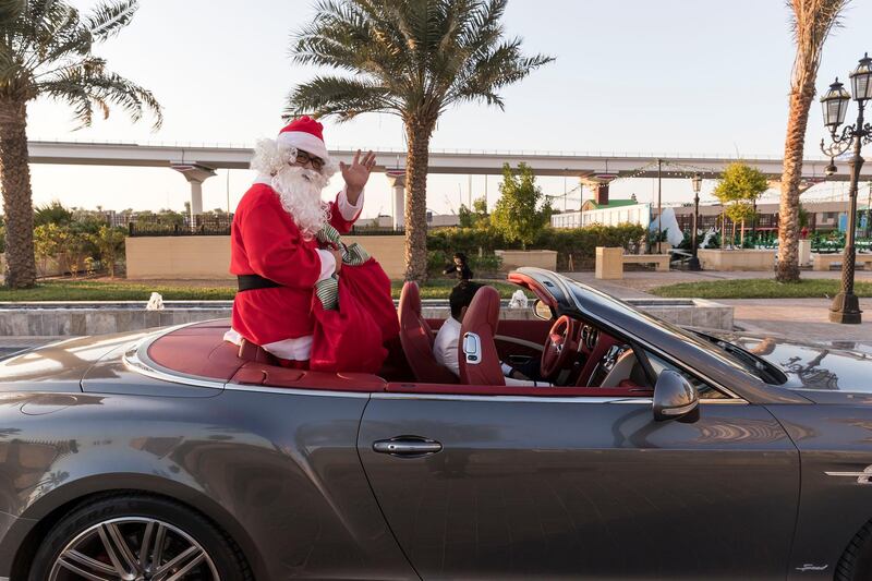 DUBAI, UNITED ARAB EMIRATES. 20 DECEMBER 2017.  Festive activities at the Winter Garden Market, The St. Regis Dubai Gardens Al Habtoor City. Santa himself arriving in a convertible Bentley. (Photo: Antonie Robertson/The National) Journalist: None. Section: Standalone.