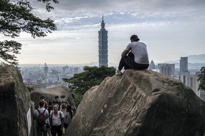 TAIPEI, TAIWAN - JANUARY 07: A man sits on a rock overlooking the Taipei 101 tower, once the worlds tallest building, and the Taipei skyline, on the top of Elephant Mountain on January 7, 2020 in Taipei, Taiwan. Taiwanese will go to the polls on Saturday after a campaign in which fake news and the looming shadow of China and its repeated threats of invasion have played a prominent role in shaping debate. Ensuring Taiwans democratic way of life has dominated an election which will be closely fought between incumbent, anti-China president Tsai Ing-wen and the more pro-Beijing challenger Han Kuo-yu. (Photo by Carl Court/Getty Images)
