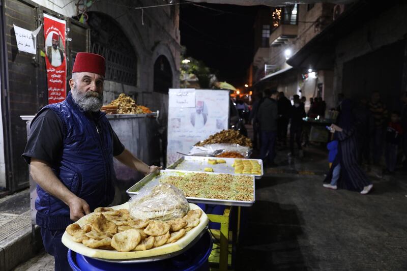 A Palestinian man sells traditional sweets in the Old City of Nablus, during Ramadan. EPA