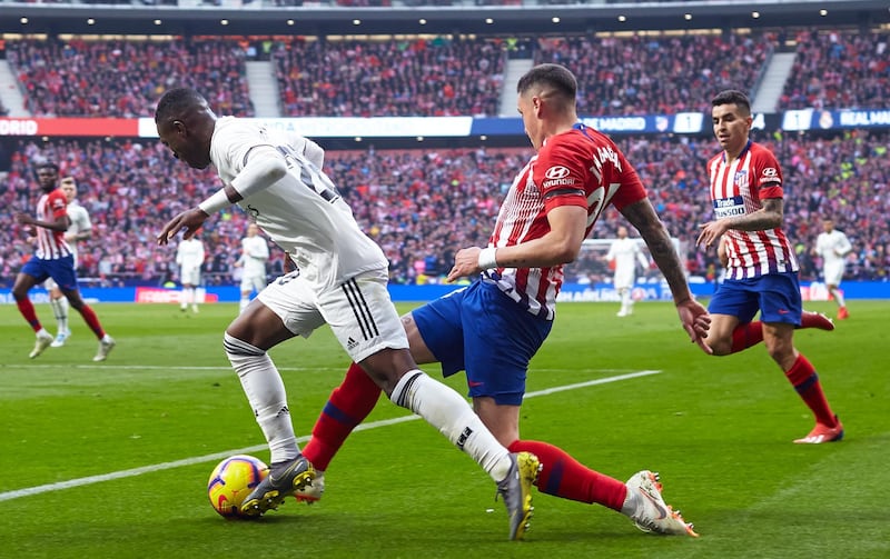 MADRID, SPAIN - FEBRUARY 09: Jose Maria Gimenez of Atletico de Madrid competes for the ball with Vinicius Junior of Real Madrid during the La Liga match between Club Atletico de Madrid and Real Madrid CF at Wanda Metropolitano on February 09, 2019 in Madrid, Spain. (Photo by Quality Sport Images/Getty Images)