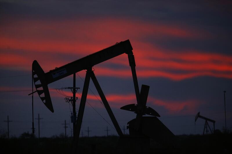 The silhouette of an electric oil pump jack is seen at dusk in the oil fields surrounding Midland, Texas, U.S., on Tuesday, Nov. 7, 2017. Nationwide gross oil refinery inputs will rise above 17 million barrels a day before the year ends, according to Energy Aspects, even amid a busy maintenance season and interruptions at plants in the U.S. Gulf of Mexico that were clobbered by Hurricane Harvey in the third quarter. Photographer: Luke Sharrett/Bloomberg