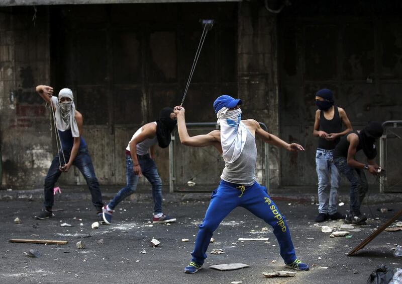 Palestinian stone throwers clash with Israeli soldiers in the West Bank city of Hebron on October 4. EPA