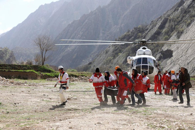 The rescue team members carry the body of a passenger of a the private jet that crashed on Sunday in the Zagros Mountains outside of the city of Shahr-e Kord. Alireza Motamedi / Tasnim News Agency via AP