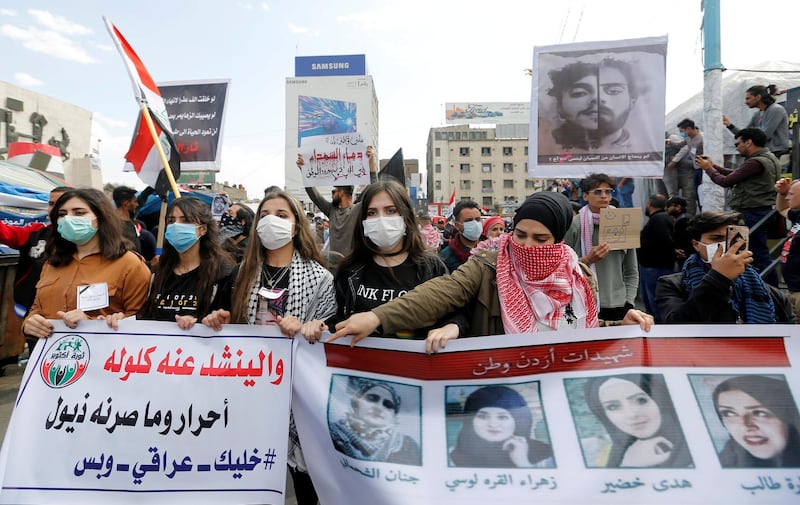 FILE PHOTO: University students girls carry pictures of demonstrators who were killed during ongoing anti-government protests in Baghdad, Iraq March 1, 2020. REUTERS/Wissam Al-Okaili/File Photo