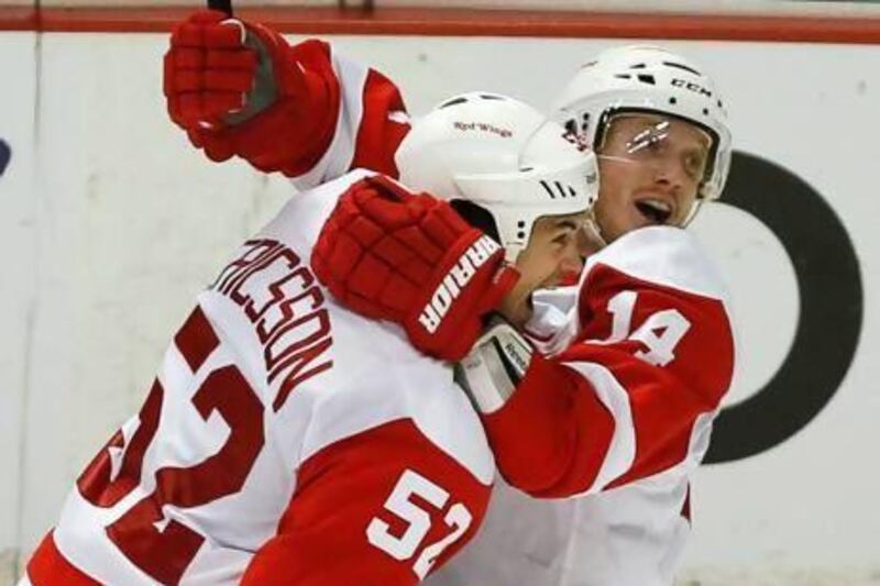 Detroit Red Wings' Gustav Nyquist, right, celebrates with team mate Jonathan Ericsson after scoring in overtime against the Anaheim Ducks during Game 2 of their NHL Western Conference quarter-final hockey playoff on Thursday. Lucy Nicholson / Reuters