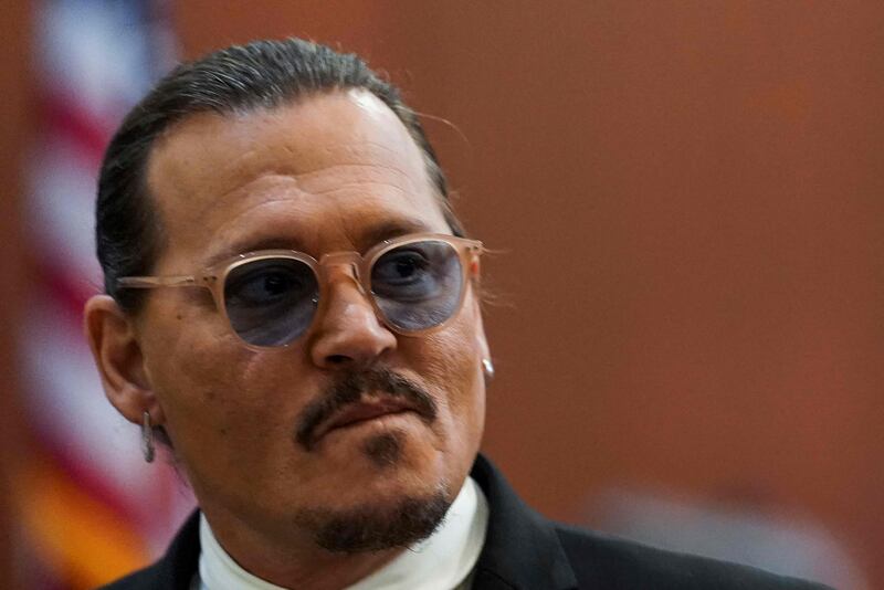 Depp looks on during a break. AFP